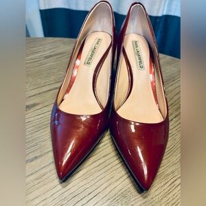 Red patent Karl Lagerfeld pumps with beautiful gold accent on heel.